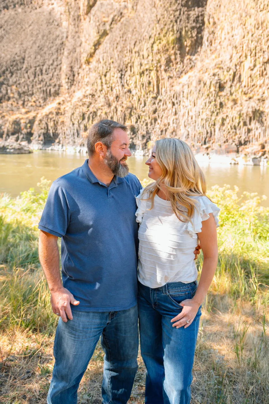 Keith Leitz with his wife beside a river below canyon walls