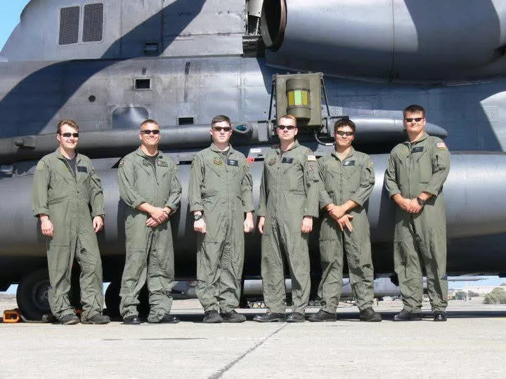 Keith Leitz with fellow service members in flight suits in front of an aircraft