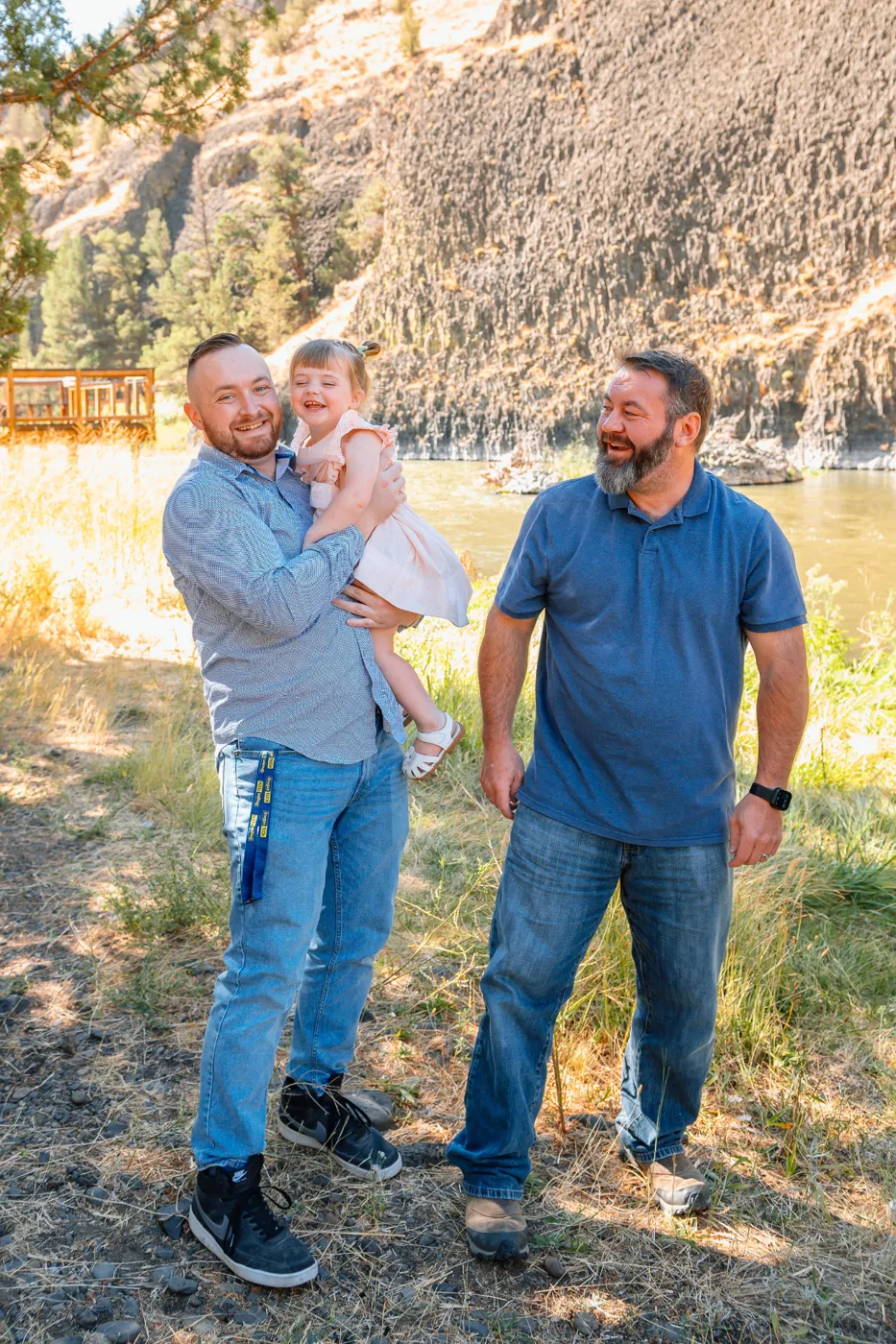 Keith Leitz outdoors with family beside a river